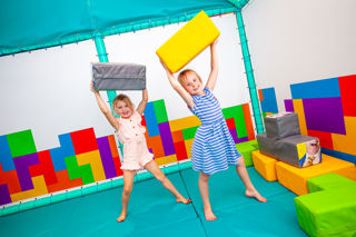 Two young girls playing with Tetris like soft play at Sooty Land