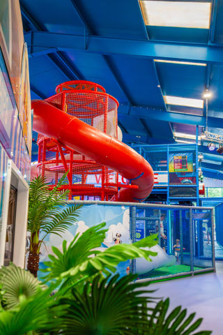An image of a curly Helta Skelta slide in a giant indoor play zone